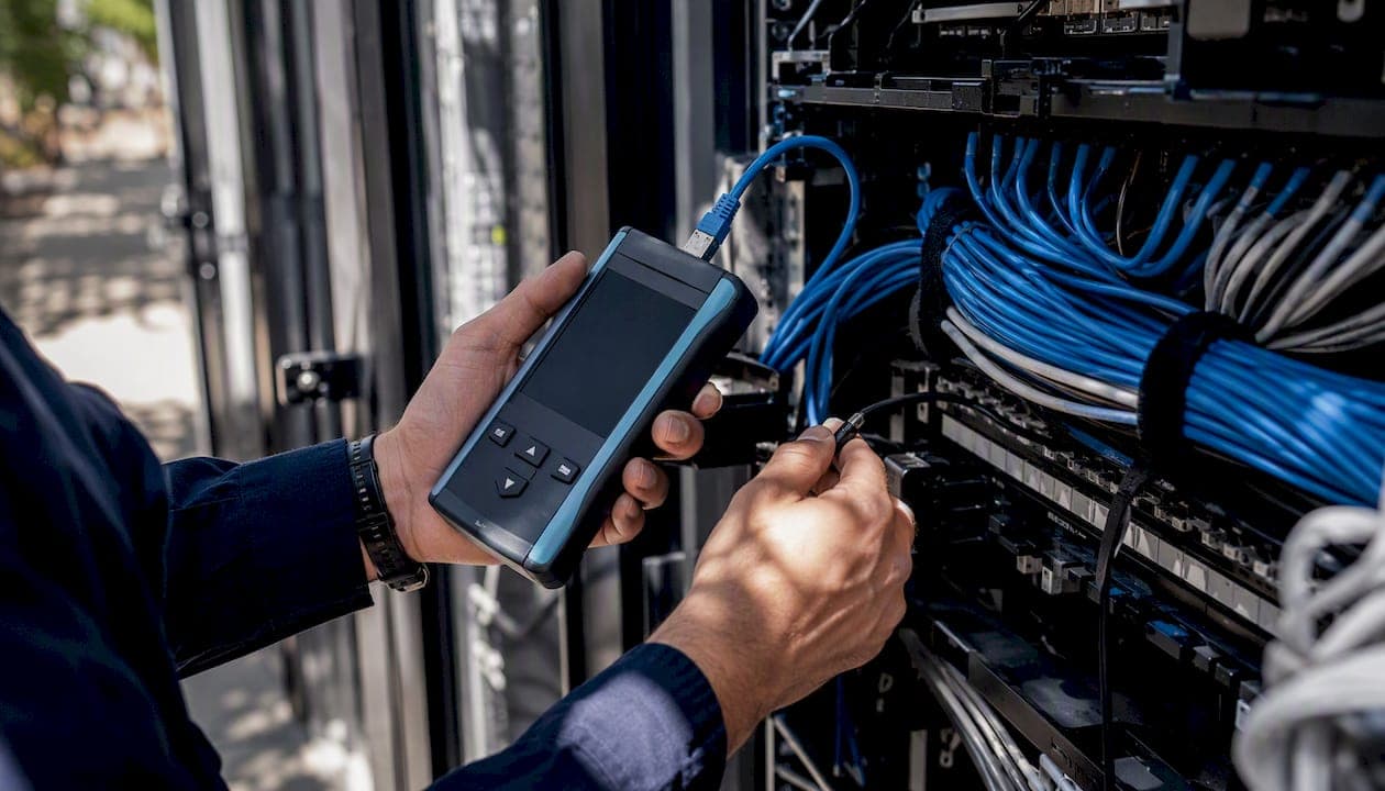 Hands conducting cable certification test